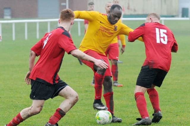 Aberford's Stefan Small uses his silky skills to defy two Rothwell defenders. PIC: Steve Riding