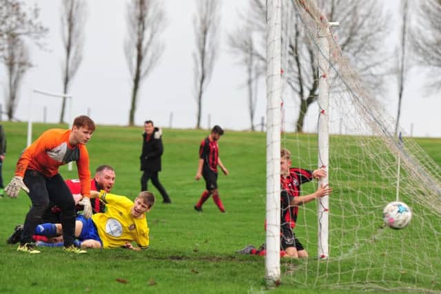 Bardsey's Eddie Clayton (pictured left in red) scores from a gaolmouth scramble. PIC: Gerard Binks Photography