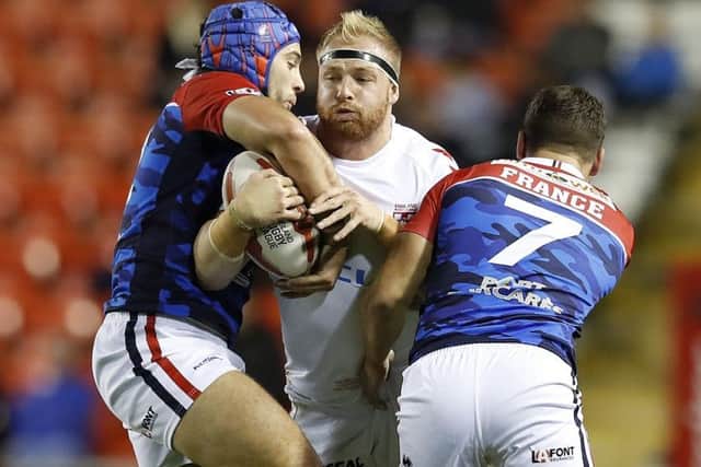 Oliver Holmes in action for England against France.