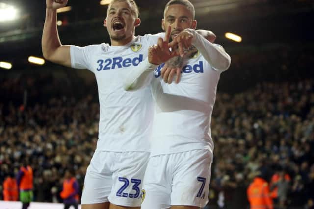 Leeds United's Kemar Roofe celebrates with Kalvin Phillips.