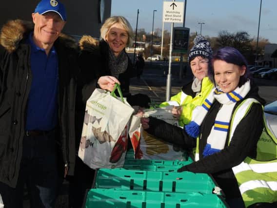 Phil and Gill Barrett from York donating food at the collection point at Elland Road at Leeds United's game on Saturday.