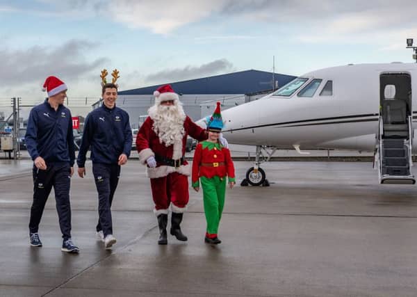 Edie Trutch, aged 10, a pupil at Collingham Primary School, and two of Yorkshire cricketers Matthew Fisher, (left), and Steven Patterson, (centre), next to Multiflight pilot Jon Everitt.