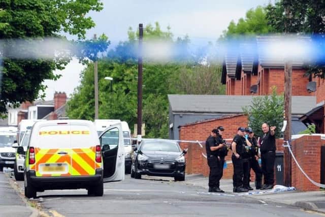 Police at the scene in Reginald Street, Chapeltown, where Christopher Lewis was fatally shot.
