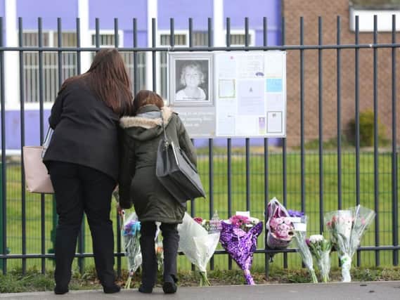 Mourners lay flowers in memory of Leeds teacher Ann Maguire. Photo: SWNS.