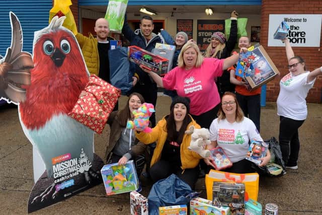 Radio Aire Mission Christmas appeal staff and  volunteers celebrating a bumper toy appeal at appeal HQ The Store Room, Millshaw. PIC: Simon Hulme