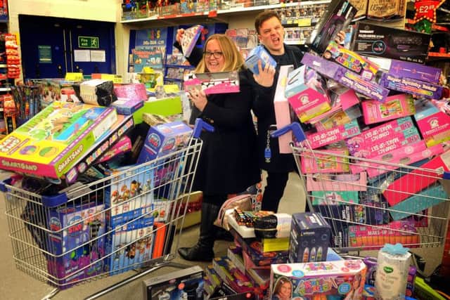 11 december  2018......  Caroline and Ant from the Radio Aire breakfast show  doing a trolley dash at the B&M store in Belle Isle along with some Cash for Kids volunteers for the YEP-backed Mission Christmas appeal.  Picture Tony Johnson.