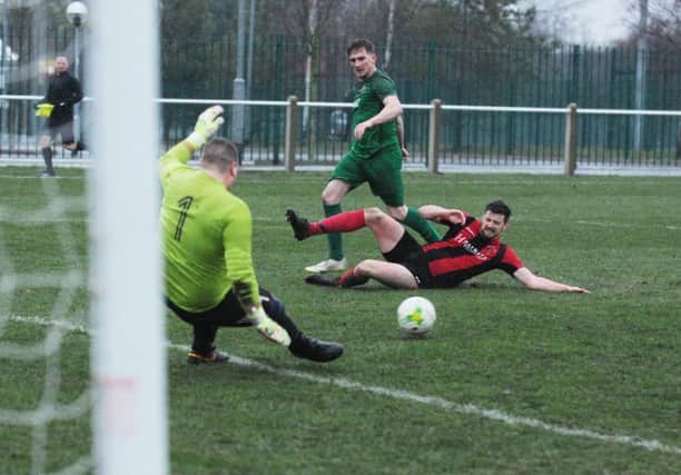 Horbury Town goalkeeper Lee Wood saves from hosts Beeston St Anthony's. PIC: Steve Riding