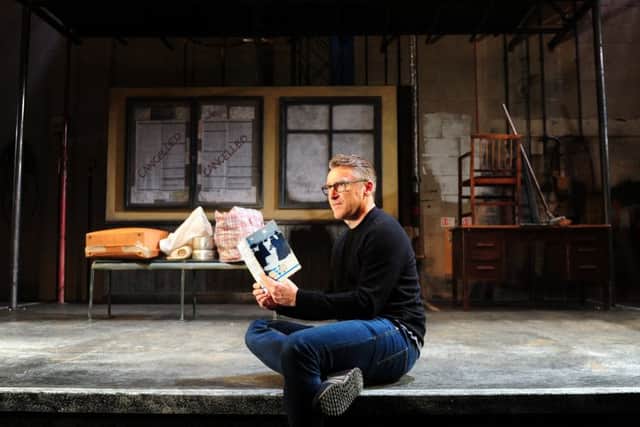 James Brining with a battered paperback copy of V, a narrative poem by Tony Harrison.