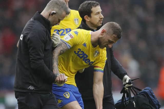 Liam Cooper goes off with an injury during the match against Sheffield United.