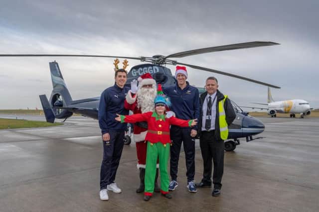 Yorkshire cricketers Steven Patterson and Matthew Fisher with Santa and helper Edie Trutch, aged 10, a pupil at Collingham Primary school and Multiflight pilot Jon Everitt.