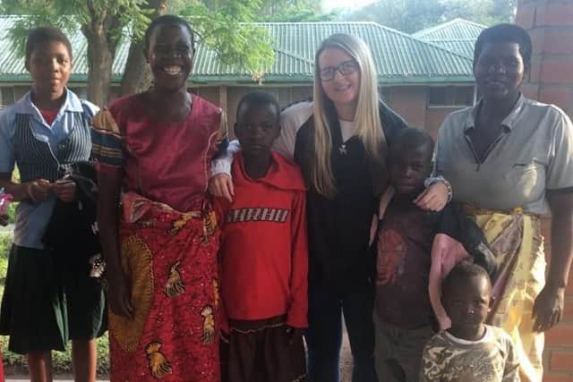 Georgia Green with Malawian children who underwent cochlear implant operations and their families.