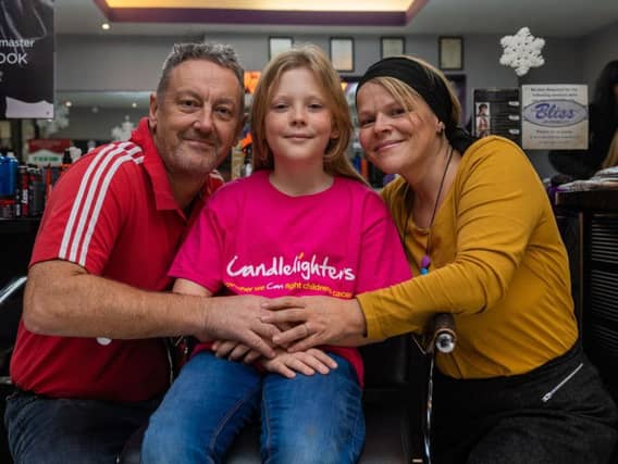 Nathan Barton-Kennedy, aged nine, with parents RIchard and Rachel, before having his hair cut at Bliss Salon in Morley.