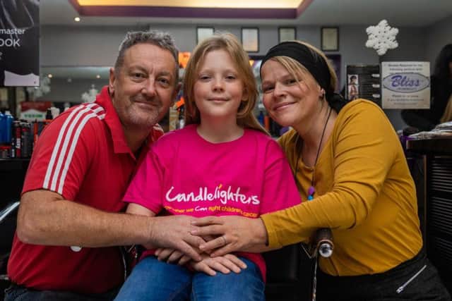 Nathan Barton-Kennedy, aged nine, with parents RIchard and Rachel, before having his hair cut at Bliss Salon in Morley.