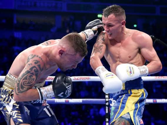 Josh Warrington lands a heavy blow on Carl Frampton during the pair's IBF featherweight clash in Manchester on Saturday.