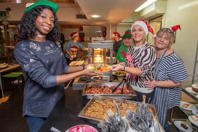 Pictured (left to right) Nicole Ruddock, Sara Howard-Blair, with mum Gina Howard, serving food.
