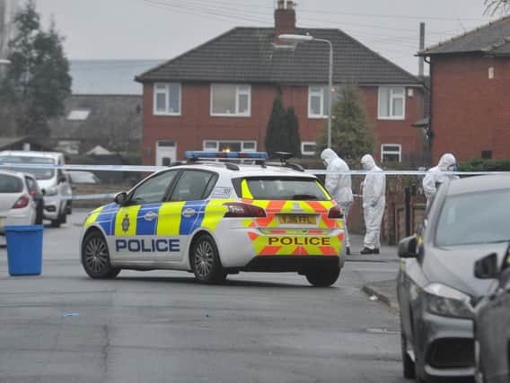 Forensic officers at the scene of a murder on Robb Street in Beeston, Leeds.