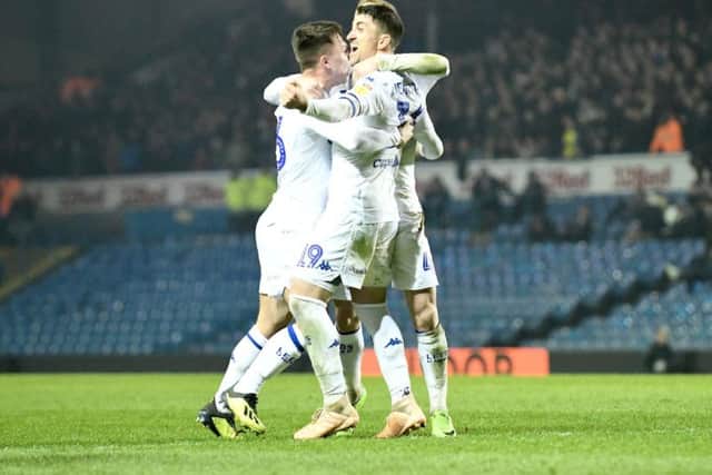 Leeds United's players celebrate at full-time.