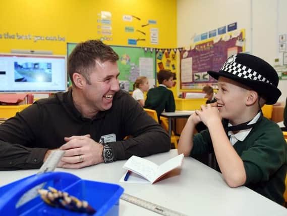 David Jackson of the LED Community Foundation chats to junior detective Tomas Robinson, aged nine, of Farsley Springbank School.