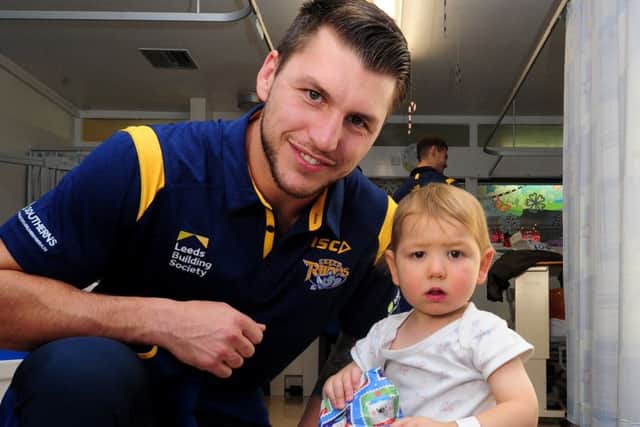 Tom Briscoe with two-year-old Jacob Warwick on a pre-Christmas visit by Leeds Rhinos players to the children's wards at Leeds General Infirmary. PIC: Simon Hulme