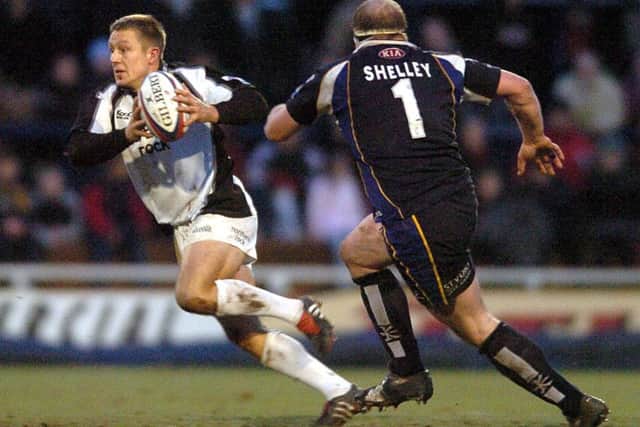 World Cup winner: Jonny Wilkinson goes past Mike Shelley in the Leeds Tykes v Newcastle Falcons match, which attracted a record Headingley crowd 14 years ago.