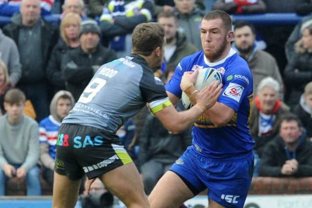 Leeds Rhinos' 
Cameron Smith takes on Wakefield Trinity's Kyle Wood during the Wetherby Whaler Festive Challenge on Boxing Day.