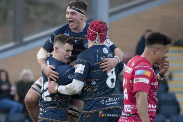 Try time: Carnegie's Harry Davey celebrates his try with Josh Bainbridge and Dan Temm.