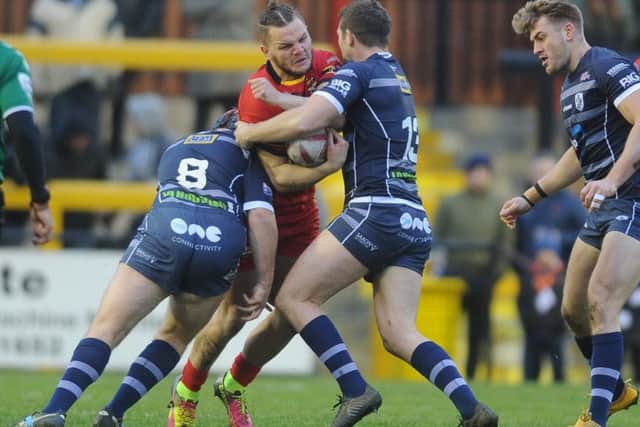 Kyle Trout is tackled by Luke Cooper and James Lockwood. Picture Tony Johnson.