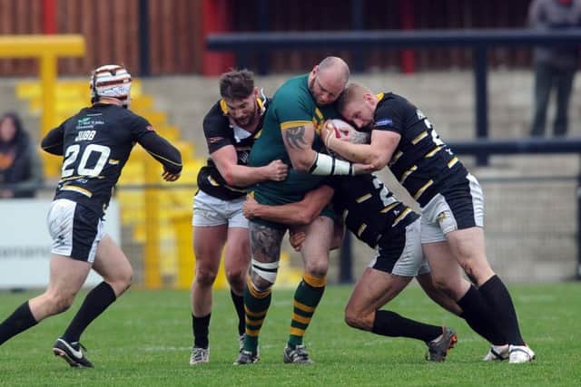 Parkside's Chris Boyce is shackled by Knights defence.  Picture Tony Johnson.