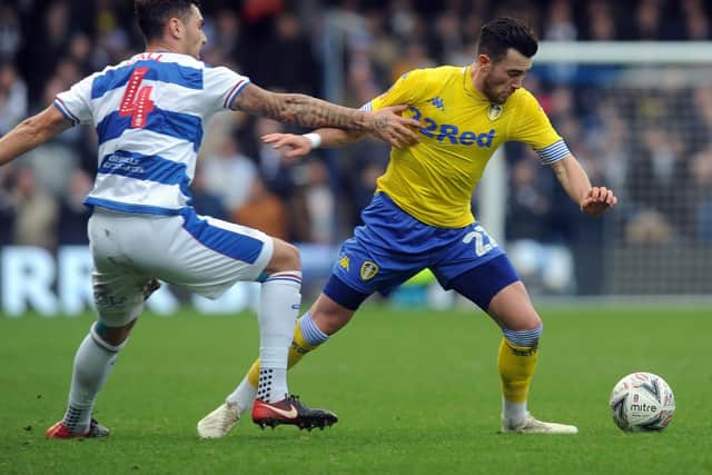 Leeds United's Jack Harrison battles with QPR's Grant Hall.