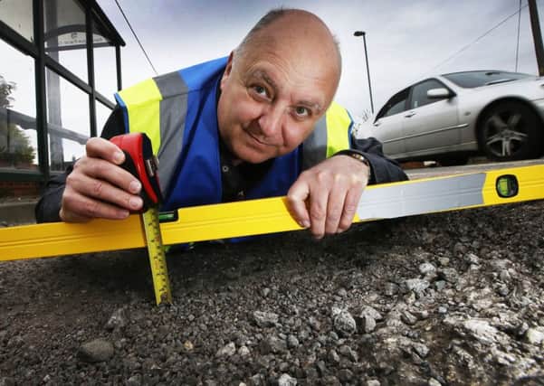 TAKING EXTREME MEASURES:  Mr Pothole Mark Morrell visits Kennington to inspect the potholes in one of Londons wealthiest boroughs in a scene from the new ITV documentary.