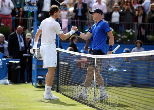 Handing over: Andy Murray and Kyle Edmund.