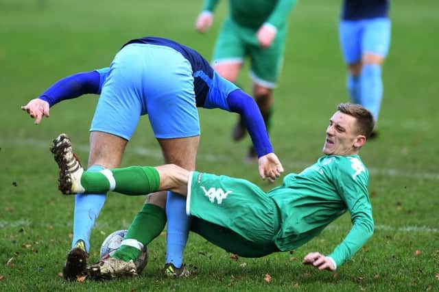 HT Sports' Sam Ackroyd tangles John Mallinson of New Pudsey. PIC: Jonathan Gawthorpe