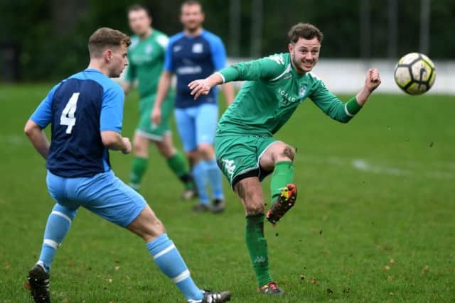 HT Sports' Joe Hill looks on as New Pudsey's Luke Kitson sets off an attack during Sunday's Leeds Combination League Jubilee Premier encounter. PIC: Jonathan Gawthorpe
