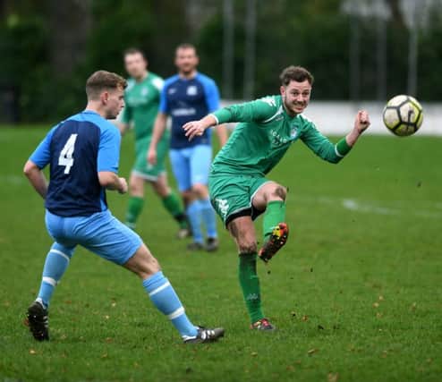 HT Sports' Joe Hill looks on as New Pudsey's Luke Kitson sets off an attack during Sunday's Leeds Combination League Jubilee Premier encounter. PIC: Jonathan Gawthorpe