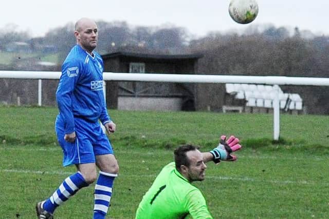 John Moore scores the third for Hall Green past Leeds Mods' goalkeeper Alex Hay. PIC: Steve Riding