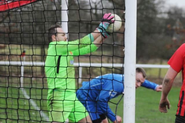Leeds Mods' goalkeeper, Alex Hay, at full stretch to thwart James Cusworth, of Hall Green United. PIC: Steve Riding