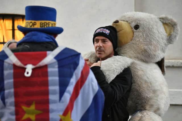 Pro-Brexit and anti-Brexit demonstrators having a chat on College Green outside the Houses of Parliament in London, ahead of a motion of no confidence in the Government. PIC: PA