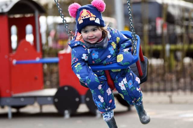 Opening of the new playground at Roundhay Park. Eloise White tries out one of the new swings.