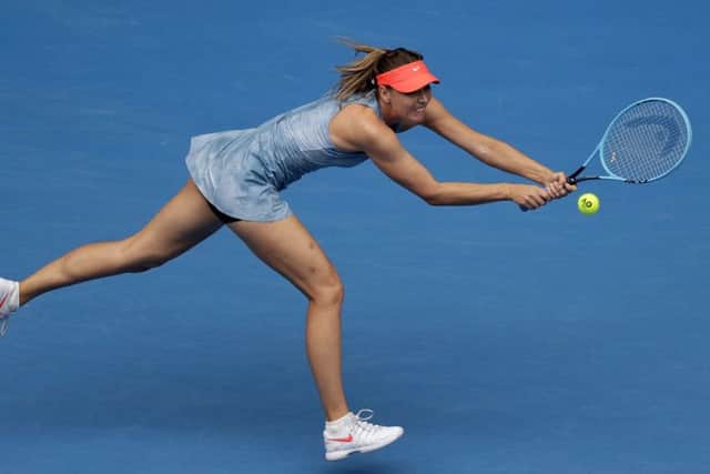 Russia's Maria Sharapova makes a backhand return to Denmark's Caroline Wozniacki during their third round match in Melbourne. Picture: AP/Kin Cheung