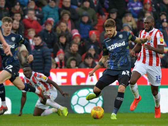 BAD DAY AT THE OFFICE: Leeds United's Matesuz Klich clears from Stoke City's Bruno Martins Indi. Picture by Bruce Rollinson.