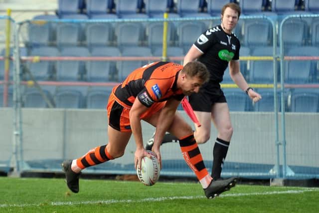 Tigers' James Clare dots down.