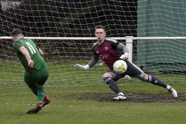 Steve Crawford scores from the penalty spot for Beeston past Carlton goalkeeper Jonathan Gardiner. PIC: Steve Riding