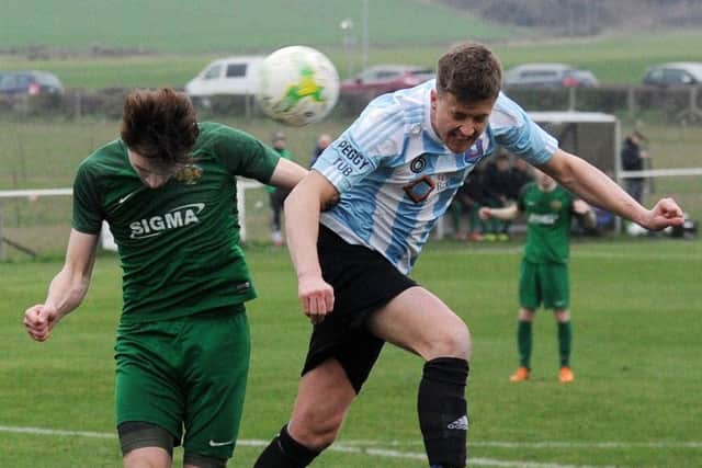 Nathan Kemp heads goalwards for Carlton past Beeston defender Matty Nebard. PIC: Steve Riding