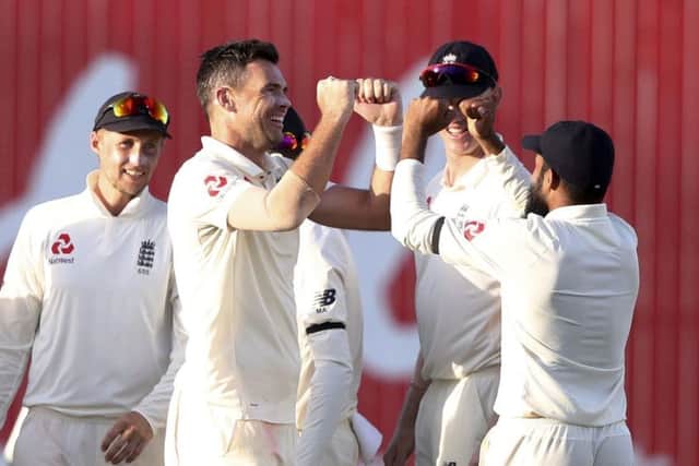 England's James Anderson celebrates with team-mates.