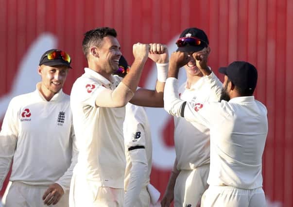 England's James Anderson celebrates with team-mates.