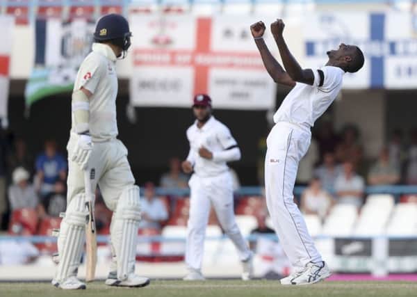 West Indies' captain Jason Holder celebrates the dismissal of England's James Anderson.