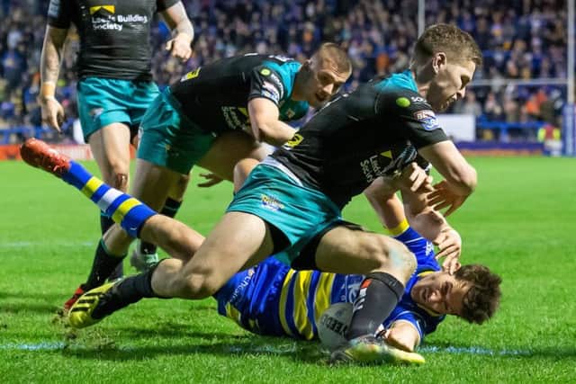 Mat Parcell can't prevent Warrington's Stefan Ratchford from scoring the first try of the match.
