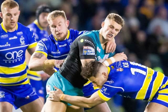 Liam Sutcliffe is tackled by Warrington's Mike Cooper and Toby King.