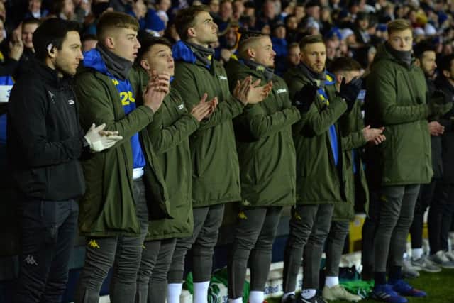 The Leeds bench joins in the minute's applause for Toby Nye.