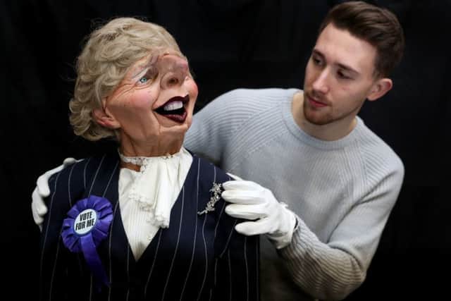 A Prop Store employee adjusts a Spitting Image puppet of Margaret Thatcher during a preview of the forthcoming Spitting Image auction at the Prop Store head office near Rickmansworth. PIC: PA